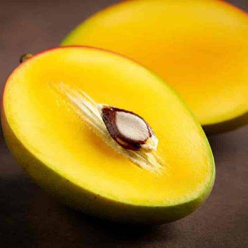 Mankurad mango cross-section showing golden-orange flesh and flat small seed